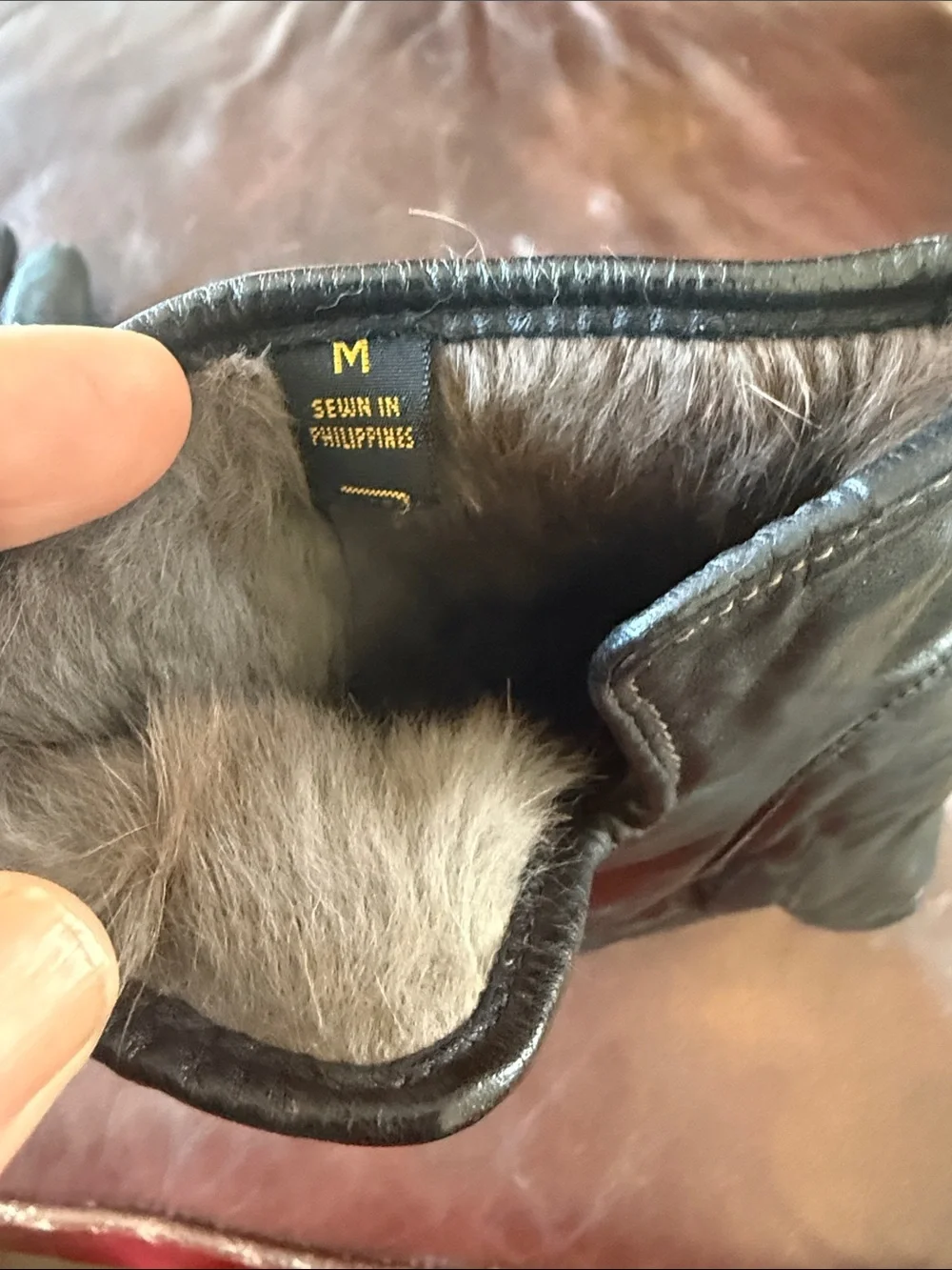 Genuine black leather gloves with genuine fur lining. Size medium
